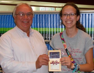Doug Lehman, Library Director, presents Hannah Hobby with a $25 gift card.